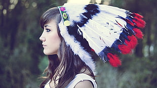 brown haired woman wearing Native american headdress
