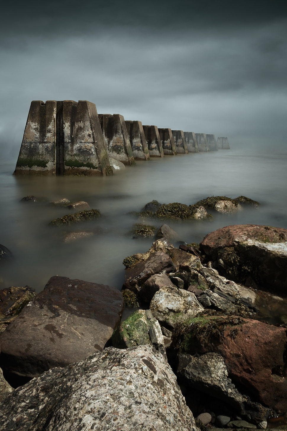 grey rock formations in fogs HD wallpaper