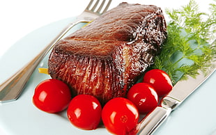 still-life photography of grilled meat with cherry tomatoes on plate