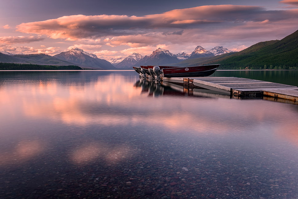 assorted outboard boats parked on wooden pier during dunset, lake mcdonald HD wallpaper
