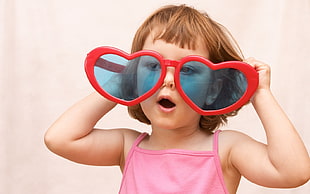 girl wearing red Heart sunglasses