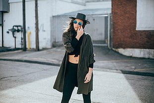 selective focus photography of woman wearing black hat and cardigan