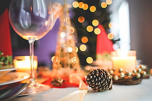 pinecone beside wine glass on wooden table