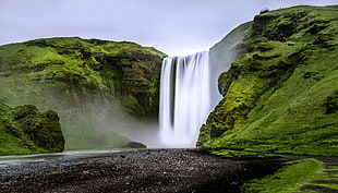 landscape photography of waterfalls on green mountain, iceland