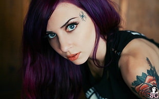 purple haired woman in black sleeveless top