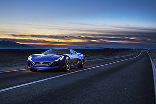 blue coupe on gray asphalt road during sun down photography