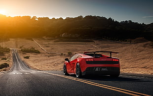 red sports car on asphalt road