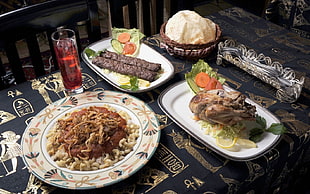 photo of cooked food with plates on table