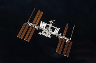 white and brown artificial satellite
