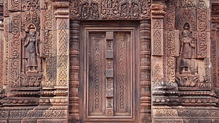 brown concrete structure door during daytime