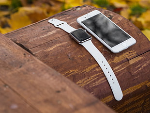 Apple band watch and iPhone 6 on top of brown wooden barrel HD wallpaper