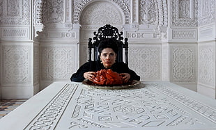woman wearing dress eating raw meat in a white wooden dining table