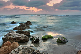 rock formation on sea shore during sunset, caesarea, israel