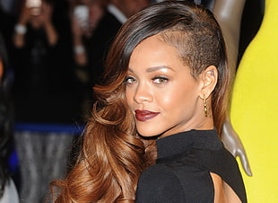 Rihanna wearing black turtle-neck top and gold-colored earrings