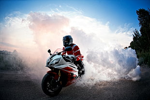 man riding white sports motorcycle during daytime