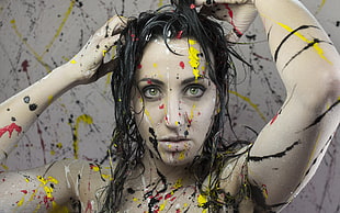 woman's face splattered with multicolored paints