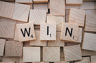 scrabble piece showing W I N letters