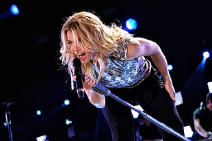 woman holding microphone on stage