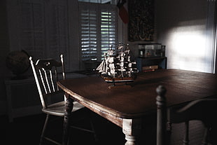 galleon ship scale model on brown wooden table inside room