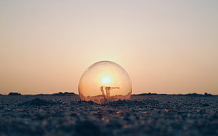 clear bubble on ground, Abduzeedo, light bulb, ground, Sun