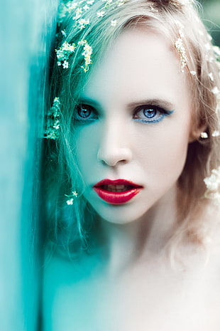 close up photography of a woman with red lips and blond hair