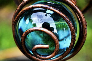 closeup photo of clear glass ball with brass coil, landscape HD wallpaper