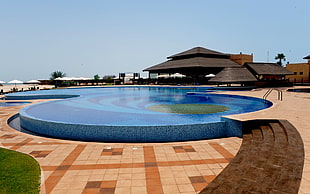 blue in-ground pool, swimming pool, beach, bungalow, resort