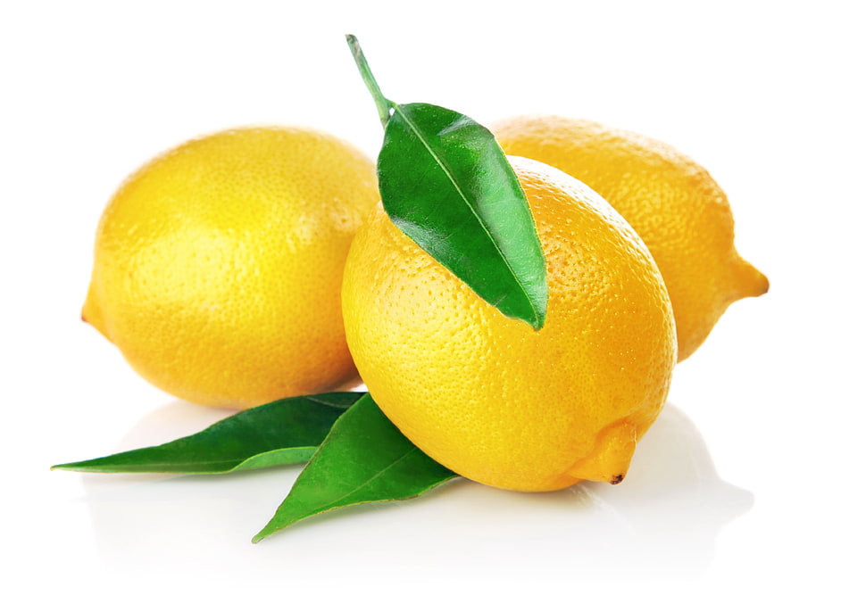 three yellow lemon with leaves on white surface HD wallpaper