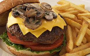 hamburger with cheese, lettuce, mushroom and french fries