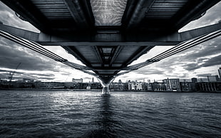 grayscale photo of under bridge, bridge, water, cityscape, sky