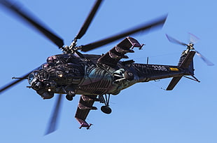 gray and brown helicopter with blue sky background
