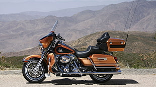 photo of brown touring motorcycle on gray concrete road
