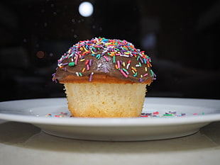 closeup photo of chocolate cupcake with sprinkles