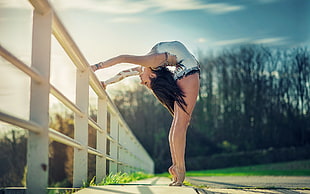 ballet dancer standing near fence
