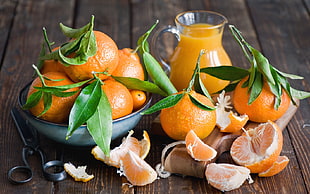 orange fruits and orange juice on wooden table