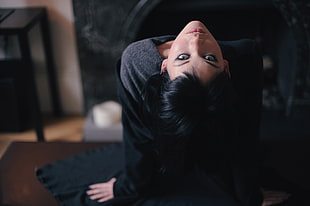 woman in black long-sleeved shirt inside room