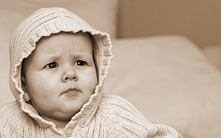 close up photography of baby wearing knitted hoodie