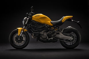 yellow and black sports bike above black surface