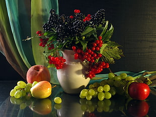 red and green fruits with white vase