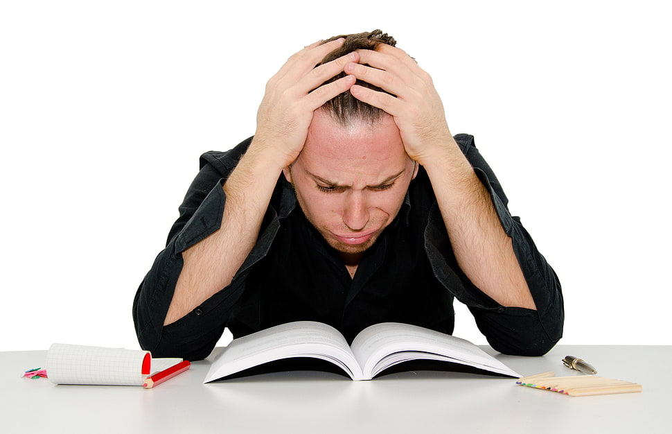man looking at book cringing HD wallpaper