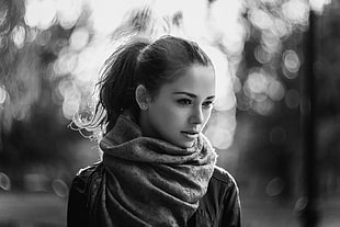 grayscale and selective focus photo of woman with scarf