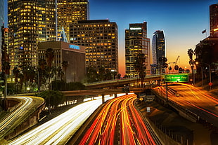 time lapse photo of cars on freeway near buildings during night, los angeles