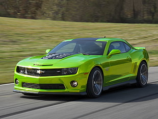 green Chevrolet Camaro on road time lapse photography