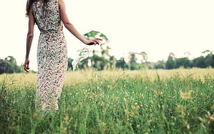 woman standing on green grass field
