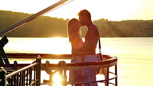 man and woman kissing near balcony during daytime HD wallpaper