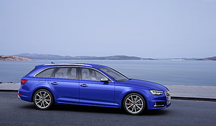 blue Audi station wagon near body of ocean HD wallpaper