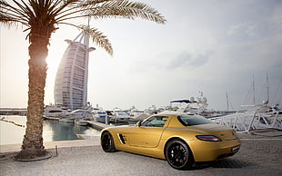 yellow sports coupe near Burj Al Arab Hotel HD wallpaper