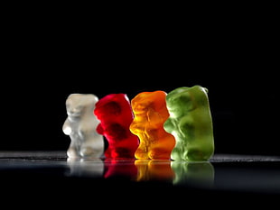 four white, red, orange, and green gummy bears