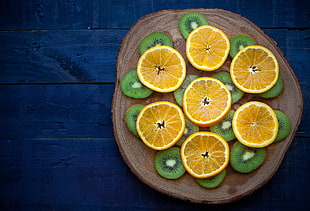 food photography of sliced kiwis and oranges