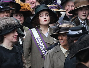 women wearing black and brown sun hats and grey coats